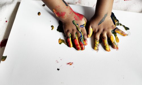 Black kid enjoying his painting